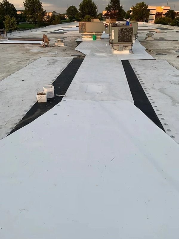 A white roof with a black stripe on the side of it.