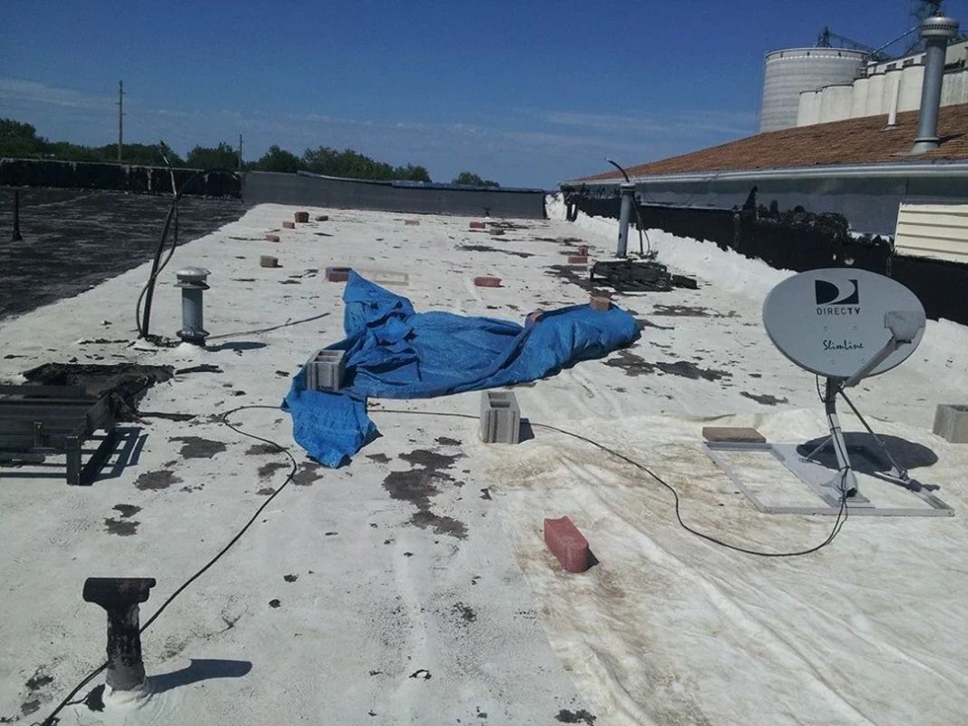 A satellite dish is sitting on the roof of a building
