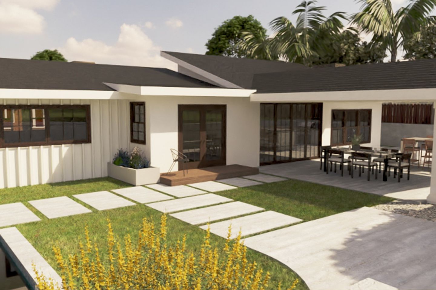 A white house with a black roof and a patio with a table and chairs.