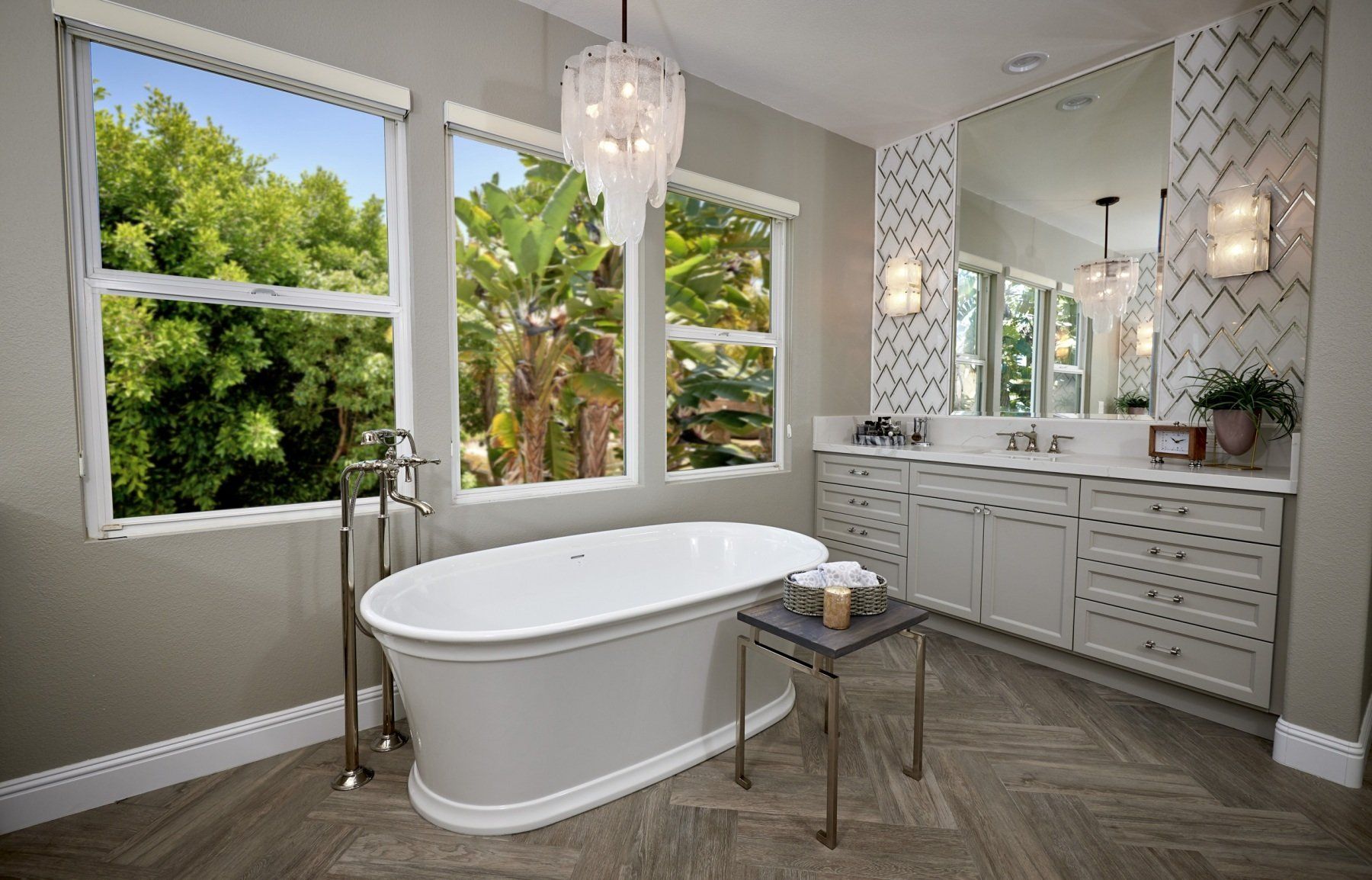 a bathtub in a bathroom with a chandelier hanging from the ceiling