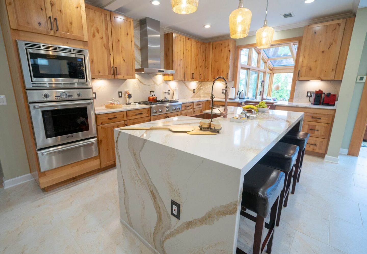 A kitchen with wooden cabinets and stainless steel appliances