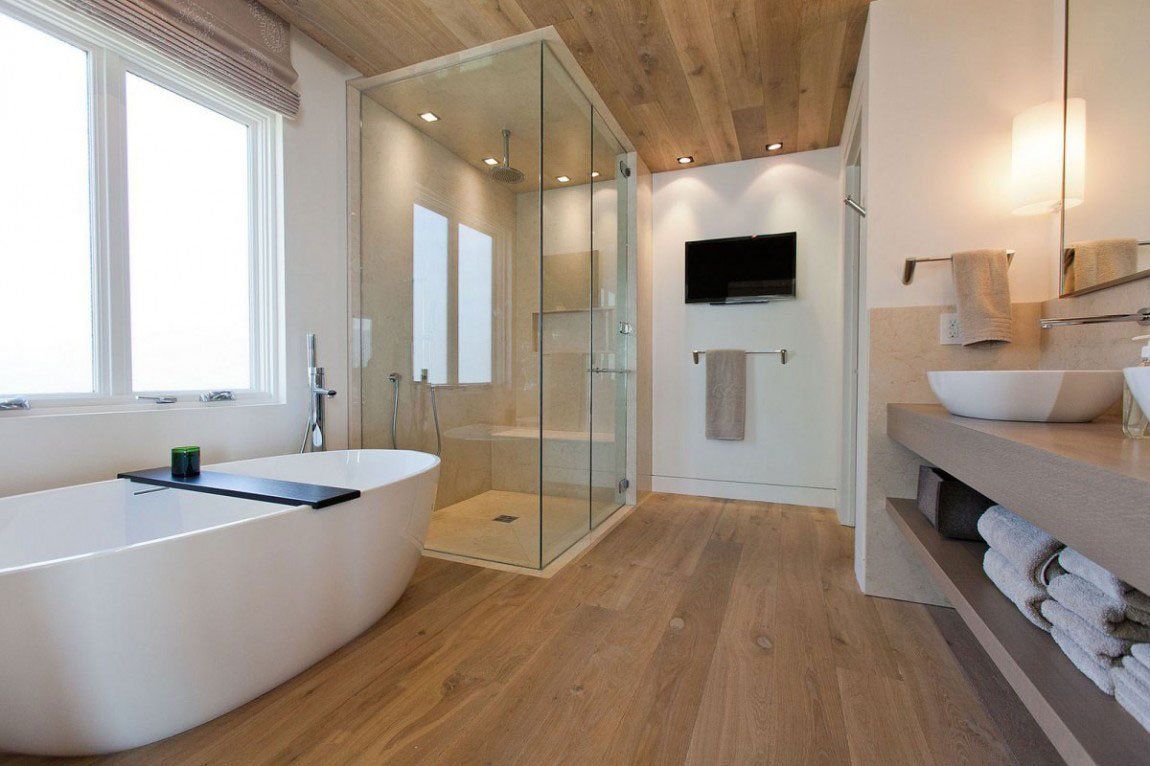 A bathroom with a bathtub , sinks , and a walk in shower.