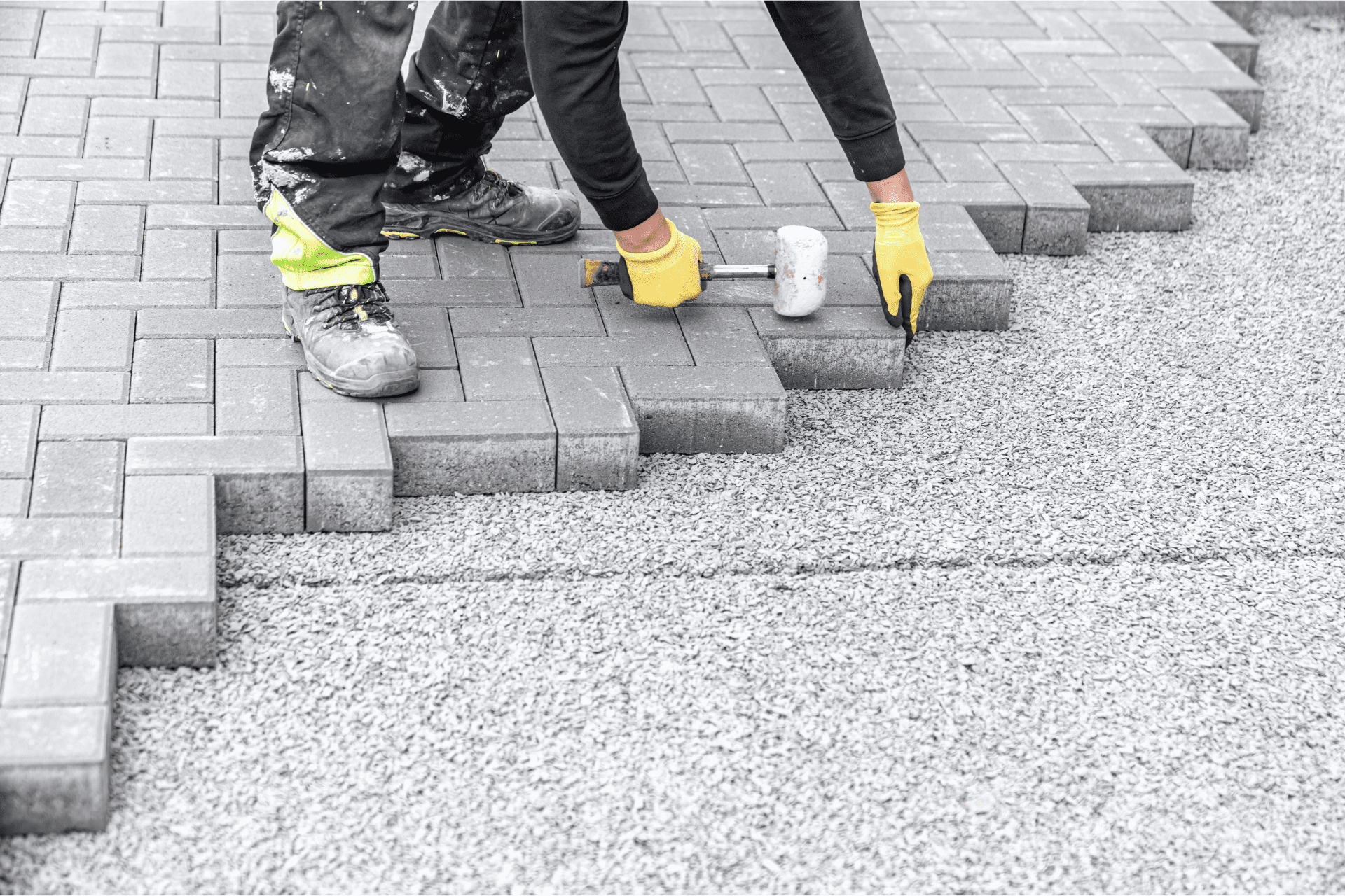 Professional Landscaper From Richmond Landscapes Installing Pavers Using Hammer In Backyard Of Richmond Home