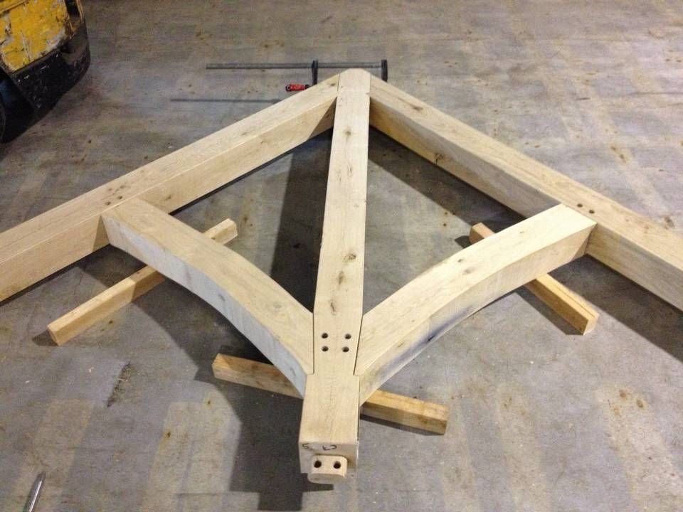 In een garage wordt een houten constructie gebouwd