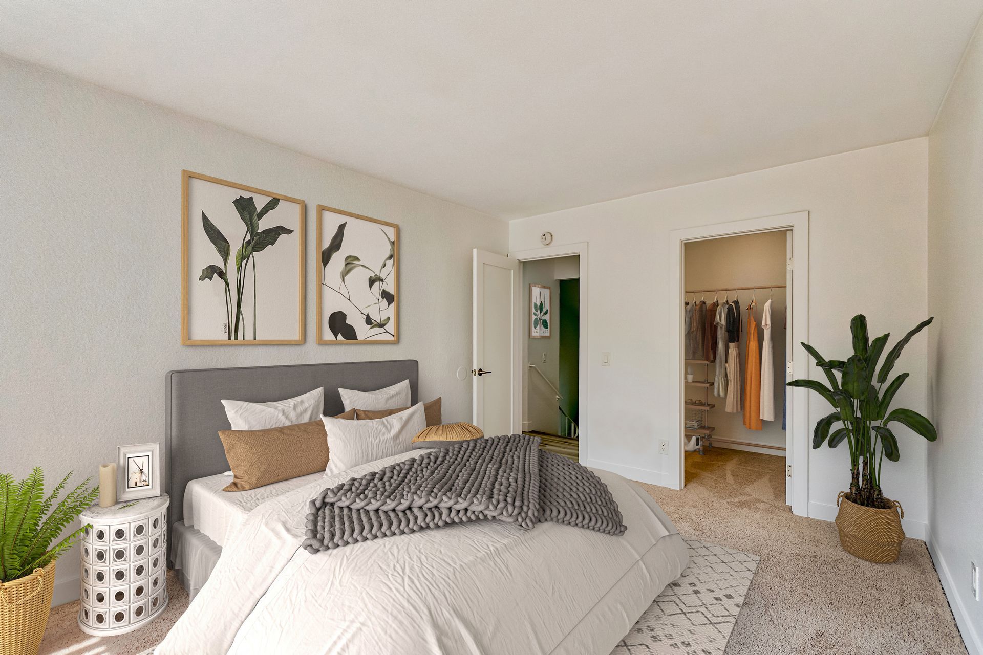 A bedroom with a large bed and a walk in closet.