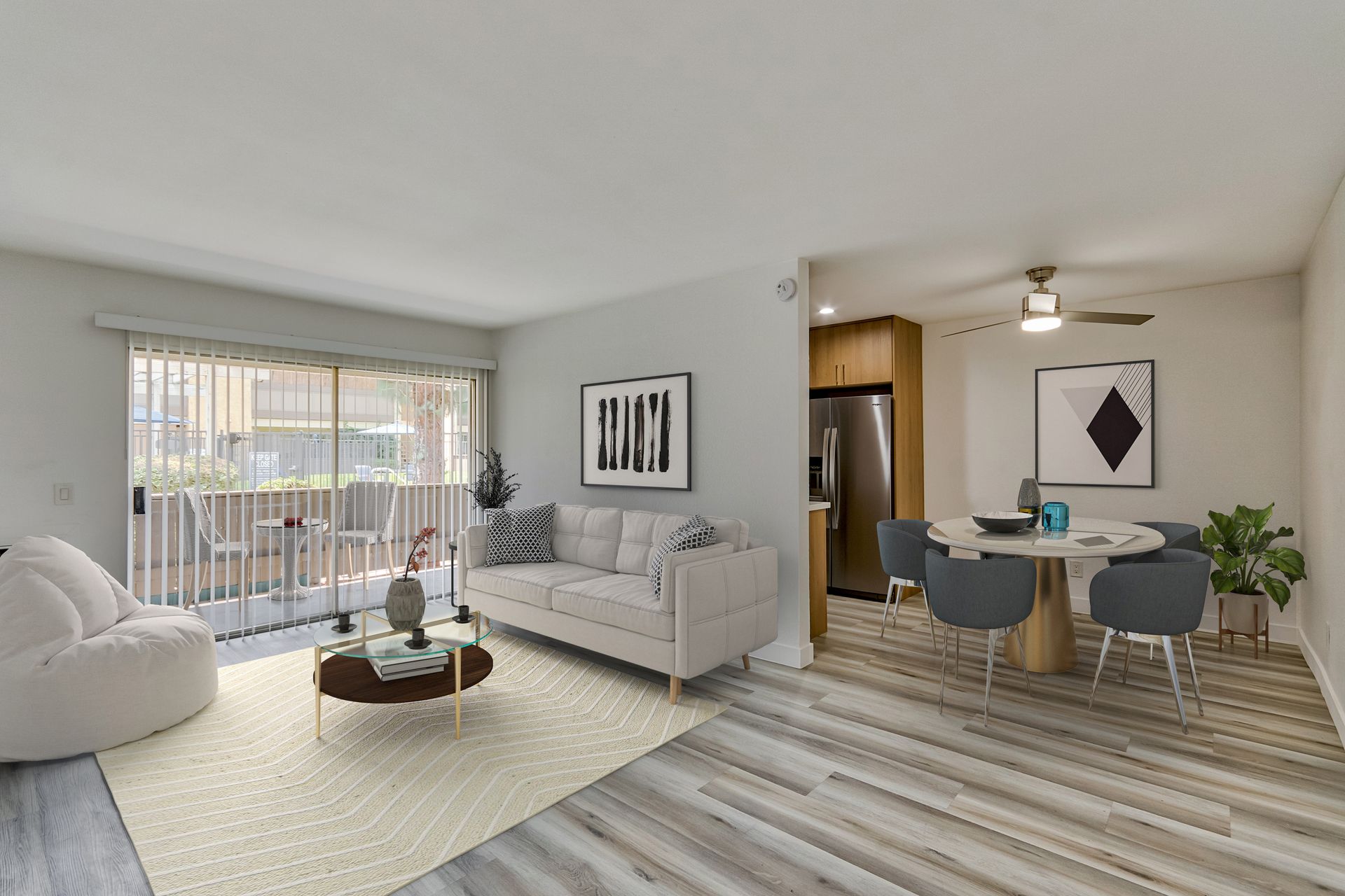 A living room with a couch , table , chairs and a balcony.
