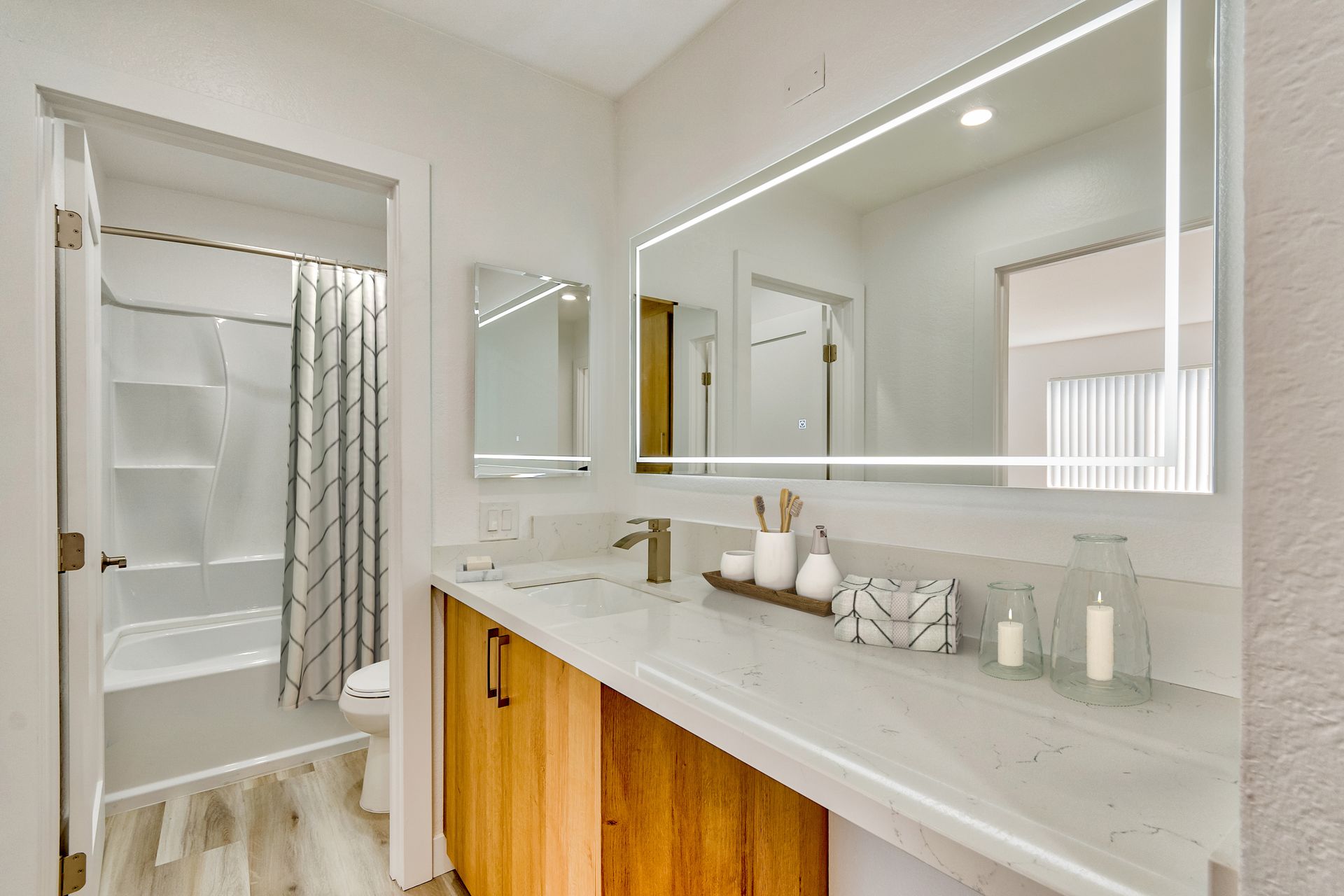 A bathroom with two sinks and a large mirror.