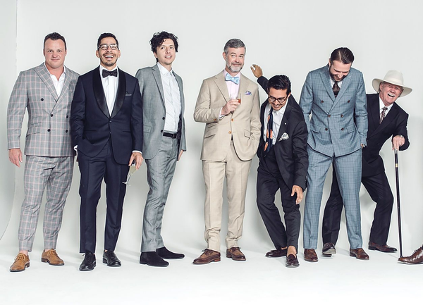 A group of men in suits are posing for a picture.