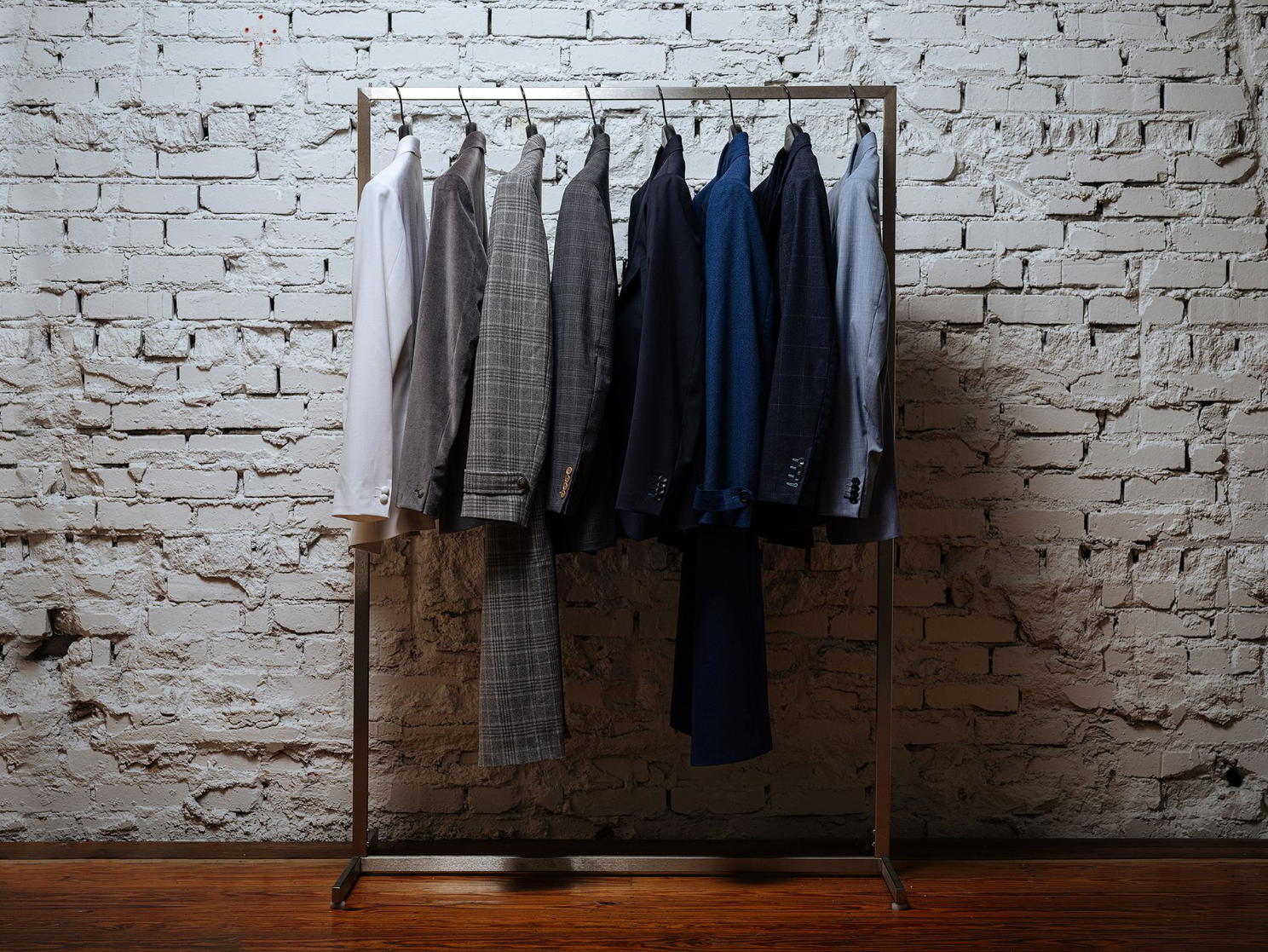 A woman is measuring a man 's arm with a tape measure.