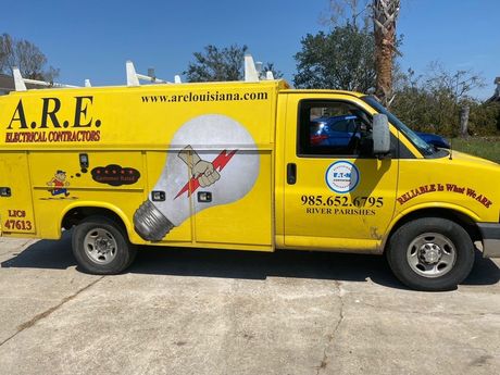 A yellow van that says a.r.e. on the side