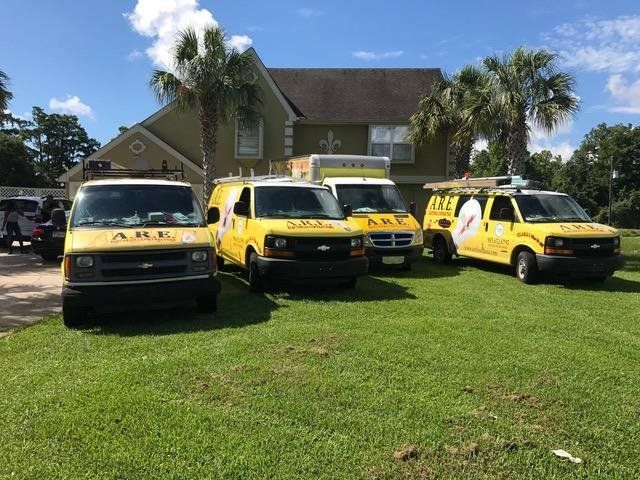 A row of yellow vans parked in front of a house