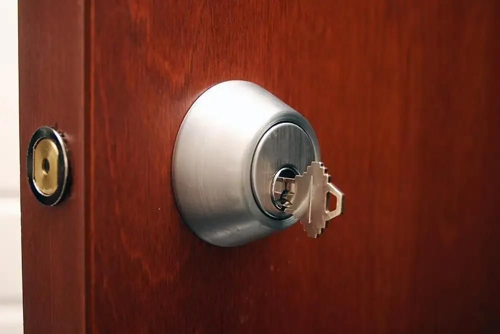 A Close up Of a Door Lock with A Key in It — The Lock Doctor in Mount Hutton, NSW