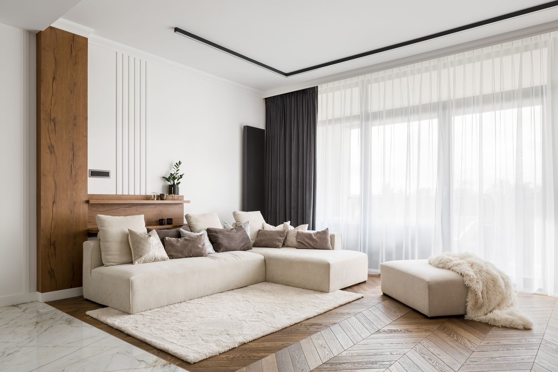 a living room with a sectional couch and a rug