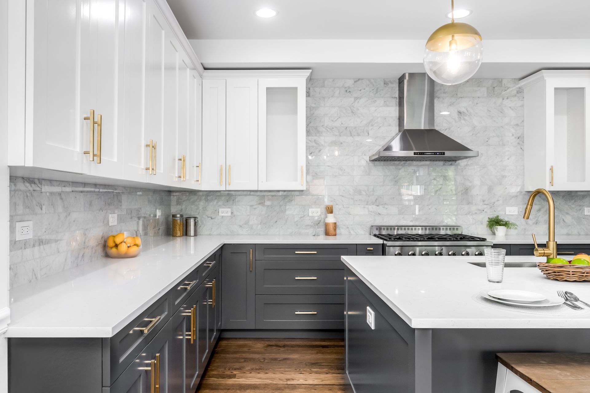a kitchen with gray cabinets and white counter tops