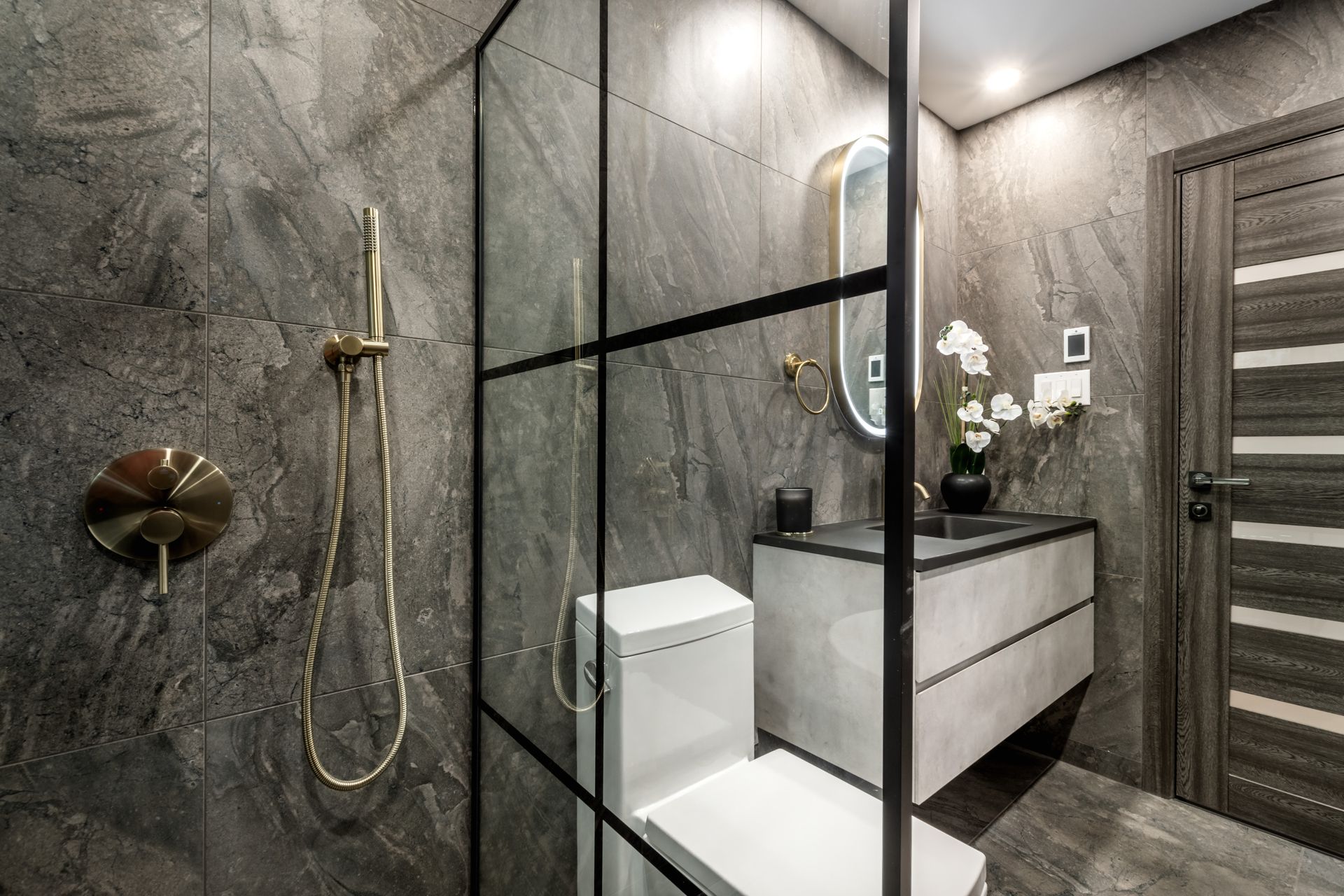 Modern bathroom with double vanity, two mirrors, and a glass shower.