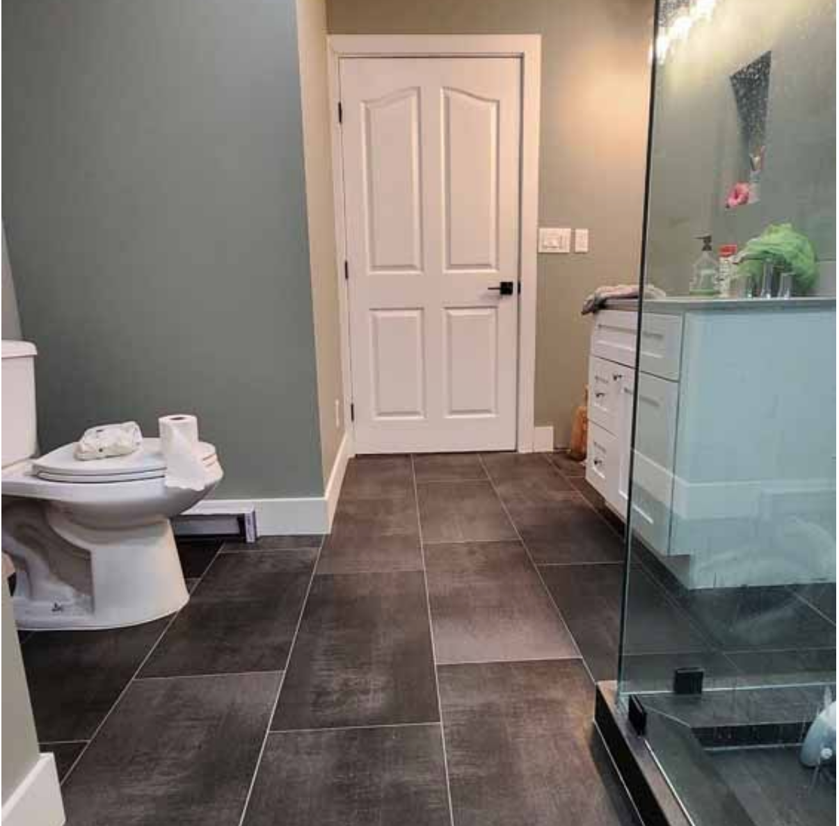 A bathroom with a toilet,sink, and shower.