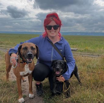 Dog walker from Muddy Paws Adventures on a countryside walk near Neston with a happy dog