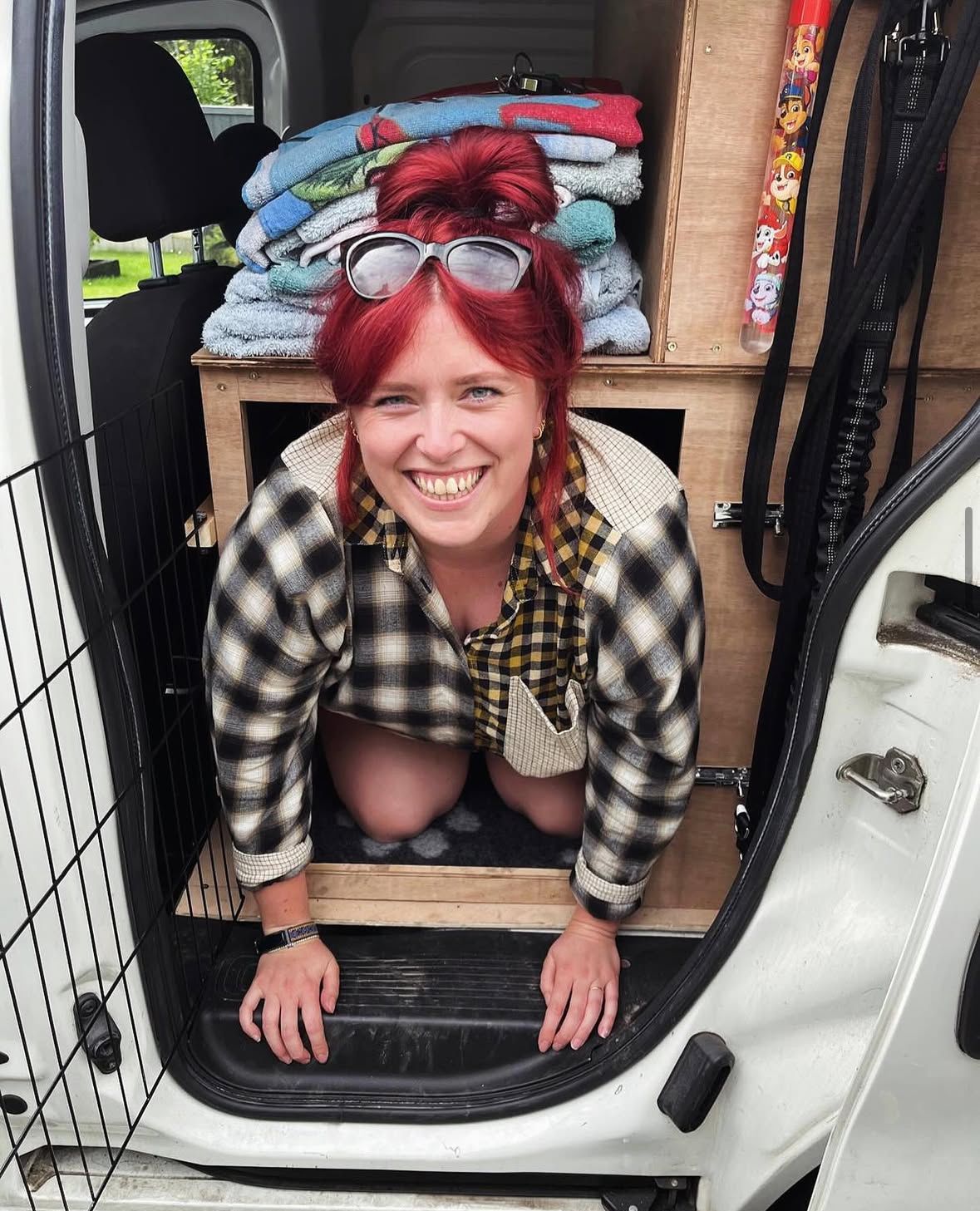 Muddy Paws Adventures dog walker smiling in the van ready for dog walks in Neston Cheshire