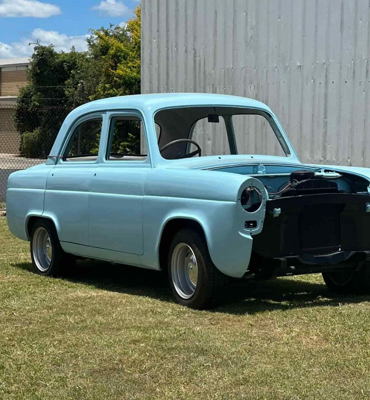 a Light Blue Car is Parked in Front of a Building. — FSK Paint & Panel in Casino, NSW 