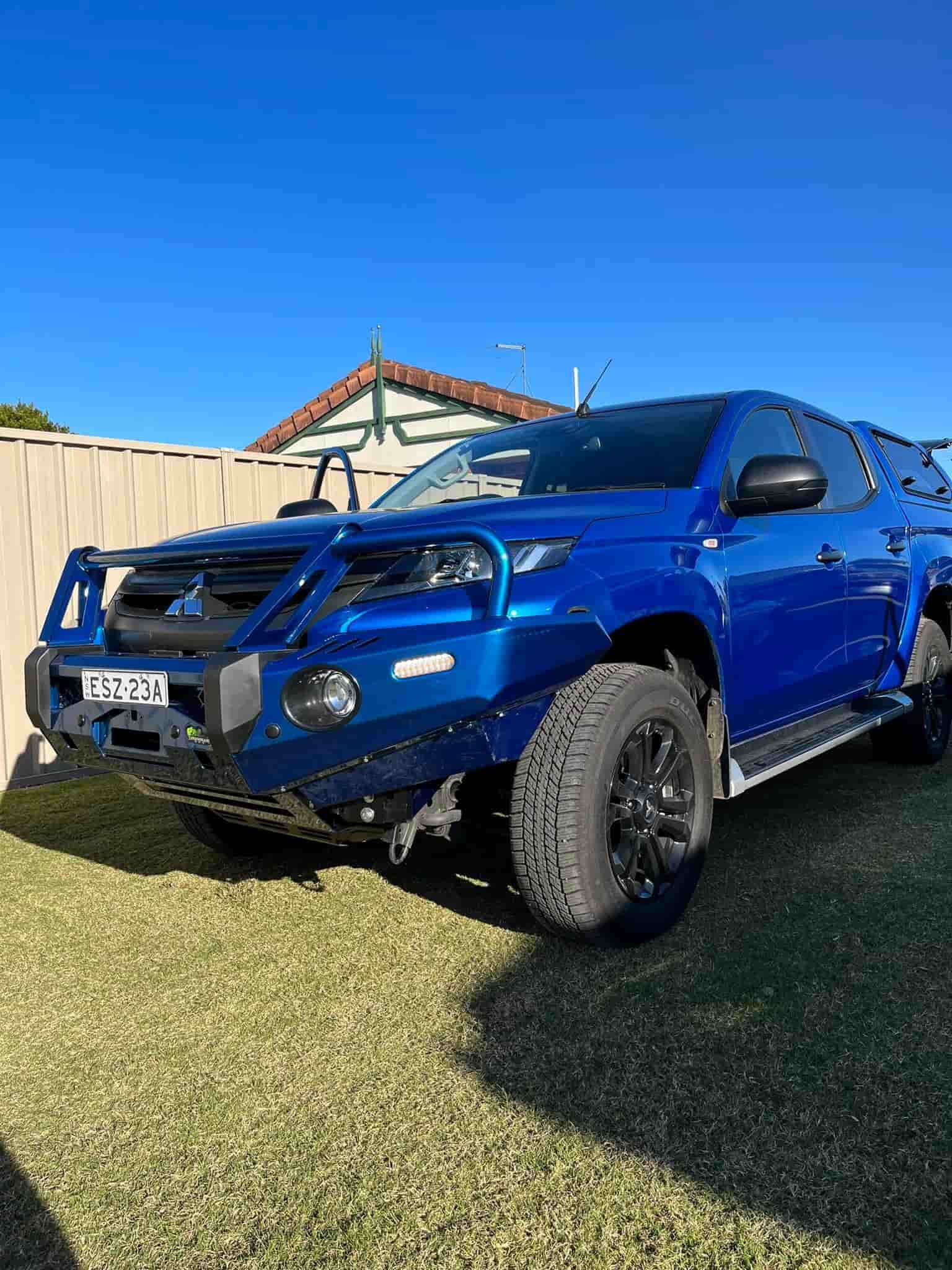 a Blue Truck is Parked in the Grass in Front of a House. — FSK Paint & Panel in Casino, NSW 