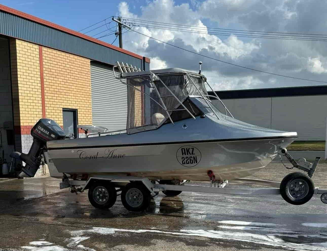 a Boat is Sitting on a Trailer in Front of a Building. — FSK Paint & Panel in Casino, NSW 
