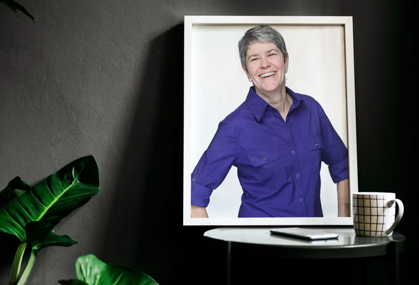 A framed picture of a woman in a purple shirt