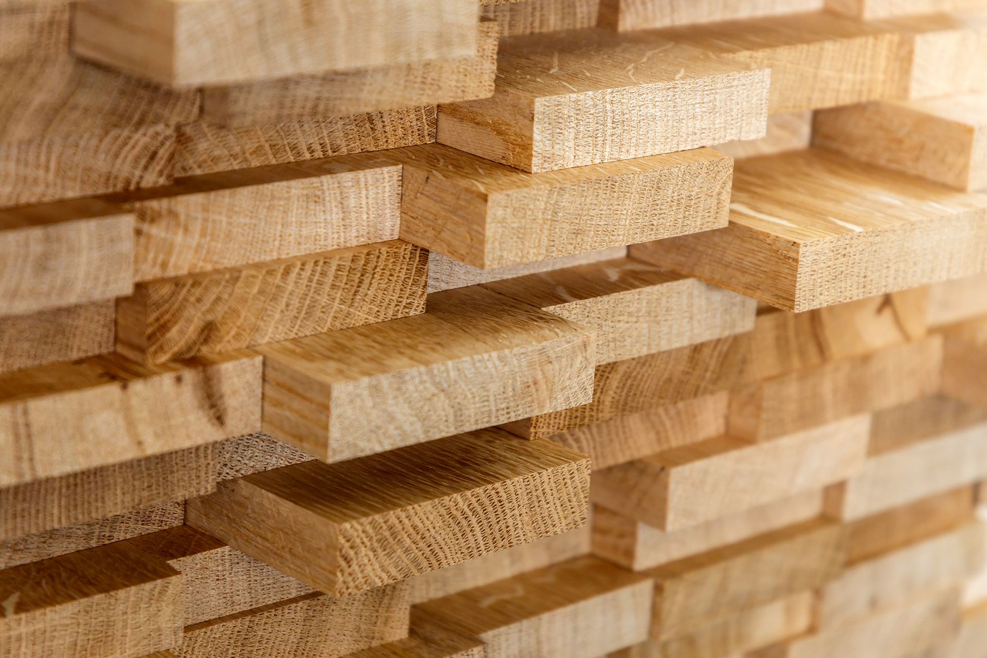 Close-up of stacked lumber products, showing cut timber ready for use in building and construction.