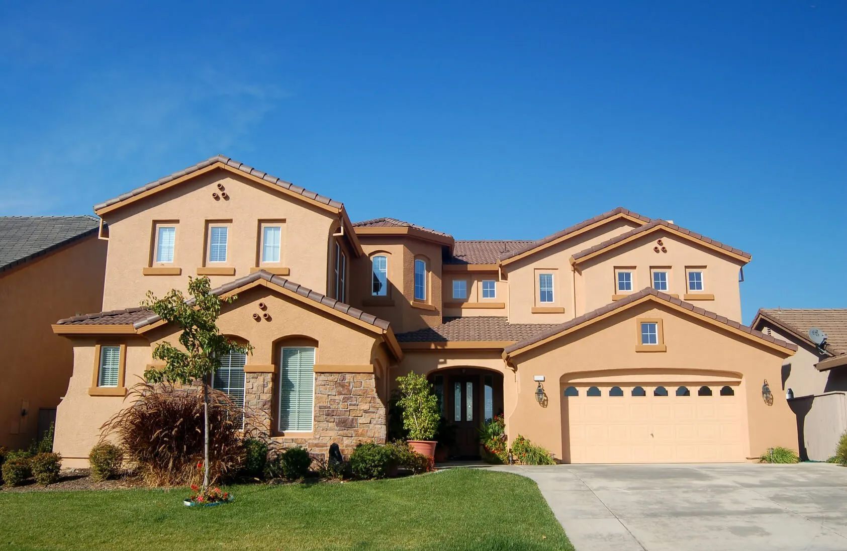 A large house with a lot of windows and a garage