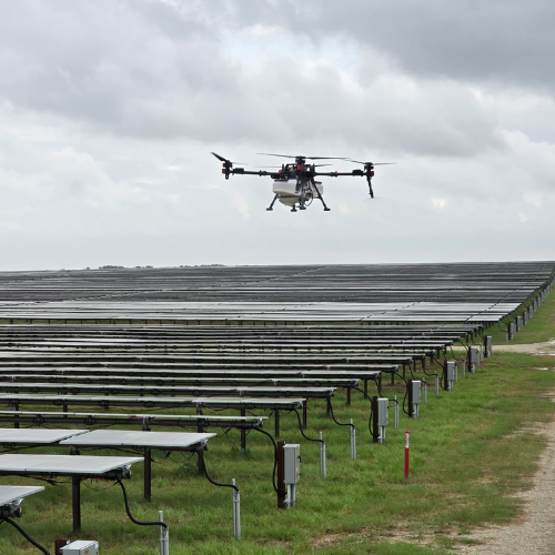 Solar panels against a blue sky with white clouds.