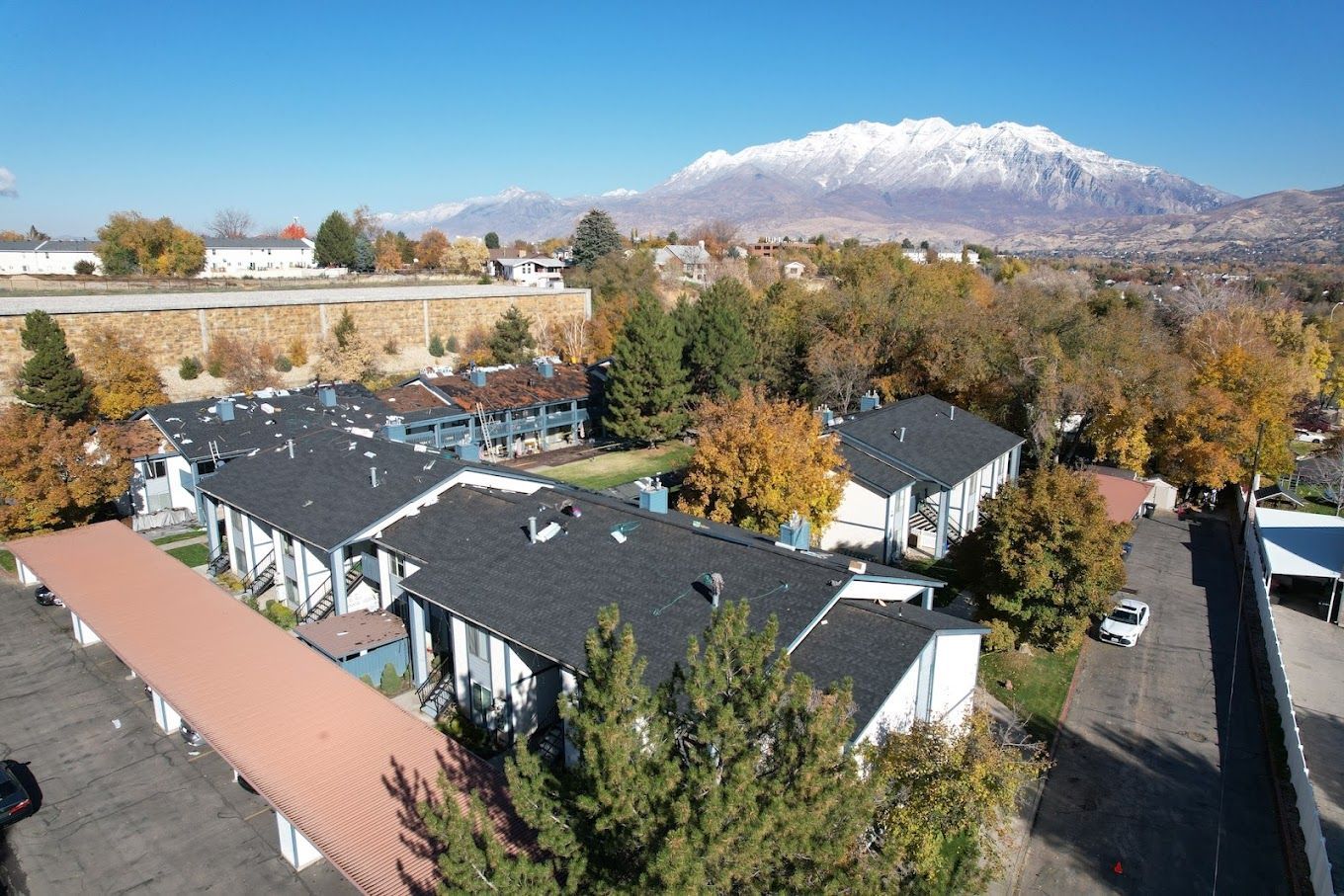 An aerial view of a apartment complex with a mountain in the background.