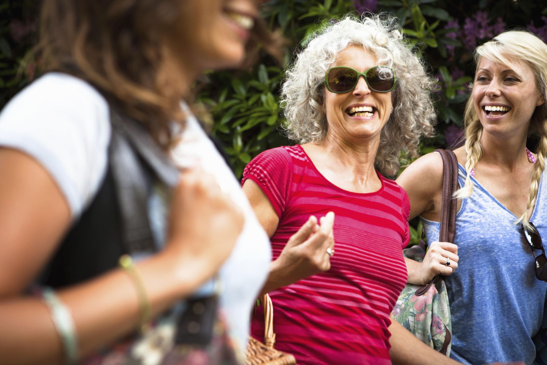 A group of women are standing next to each other and smiling.