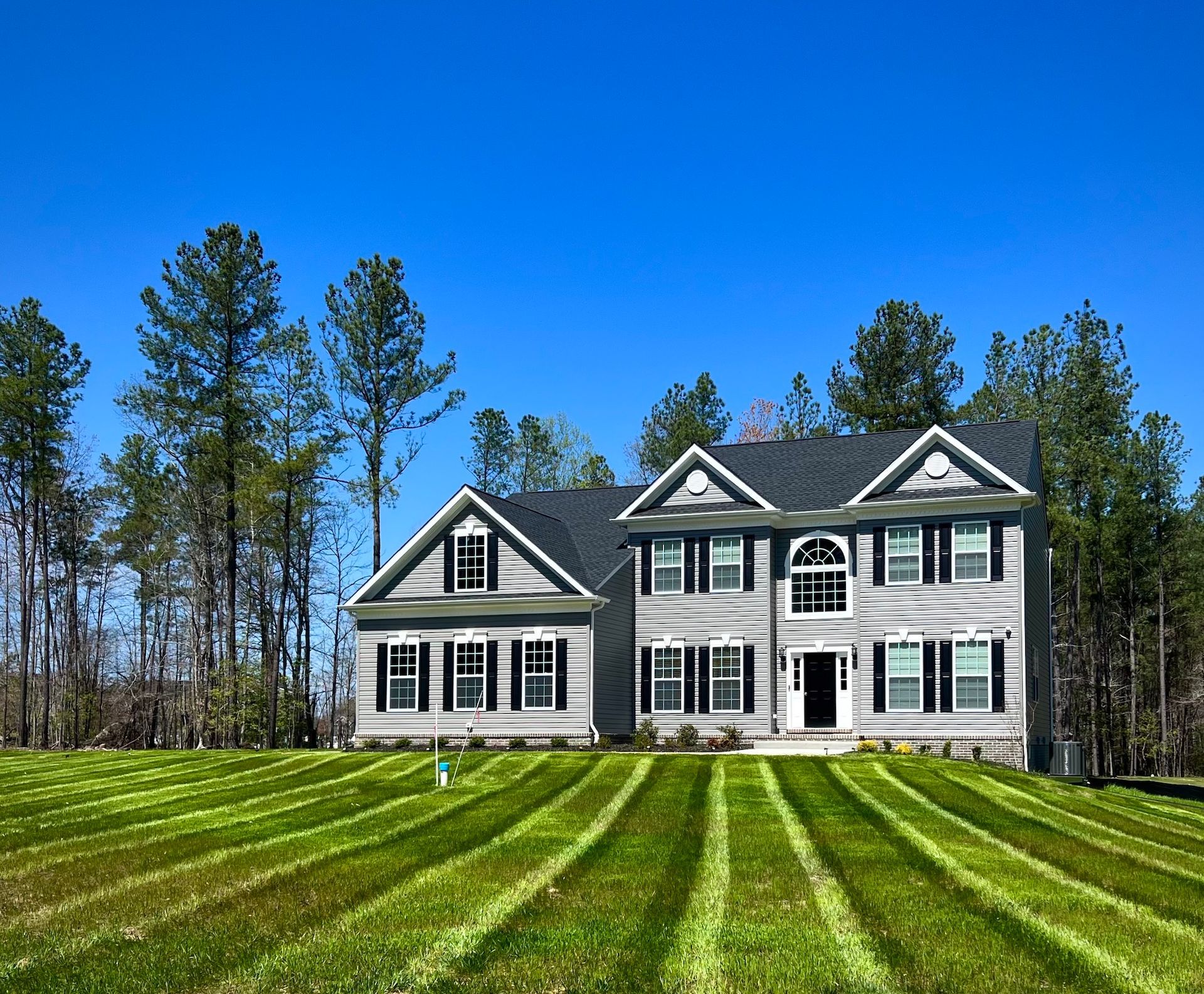 A large house with a lush green lawn in front of it