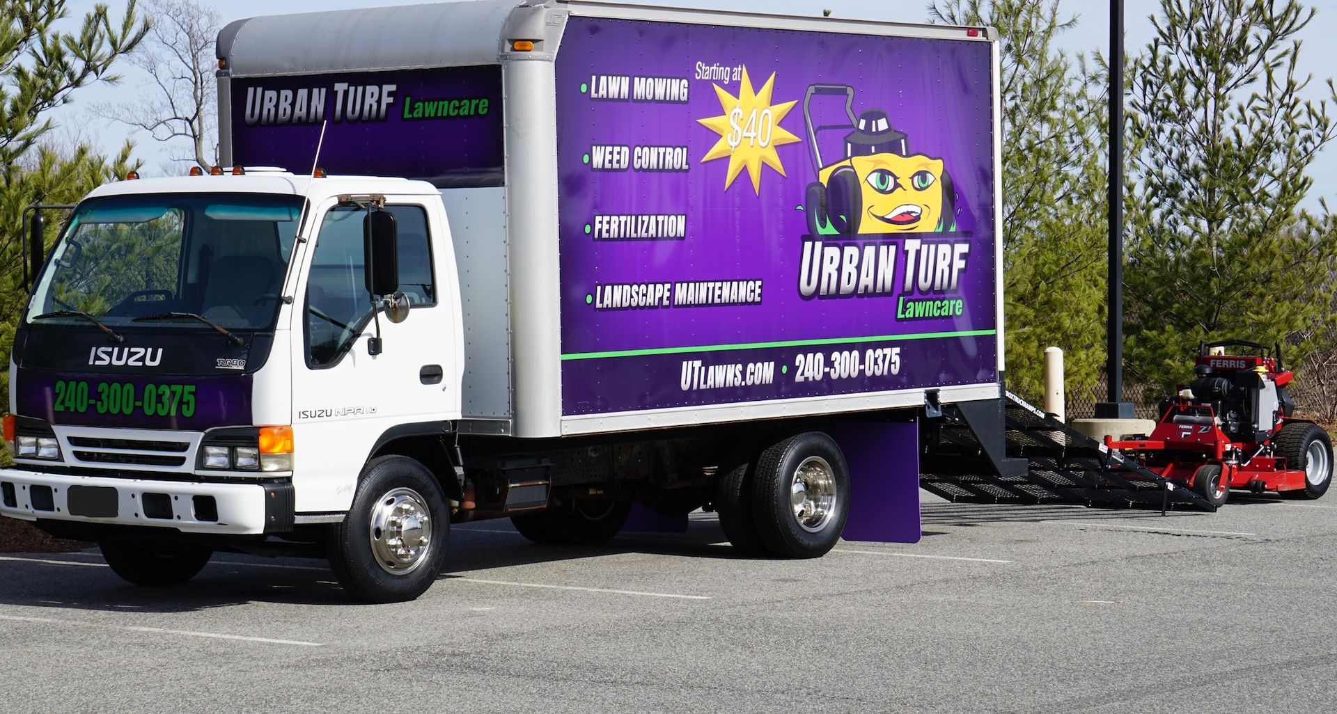 A purple urban turf truck is parked in a parking lot