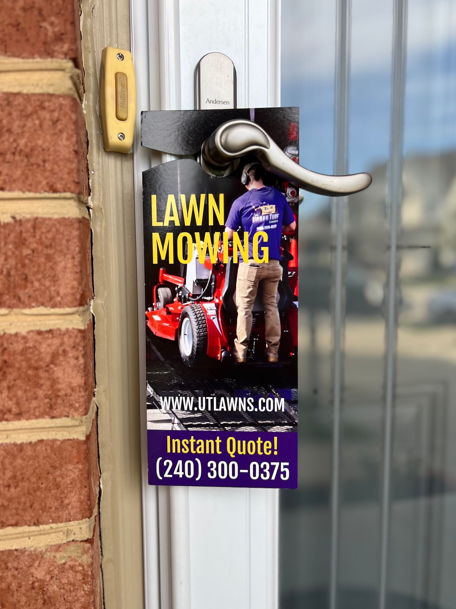 A door hanger for lawn mowing is hanging on a door