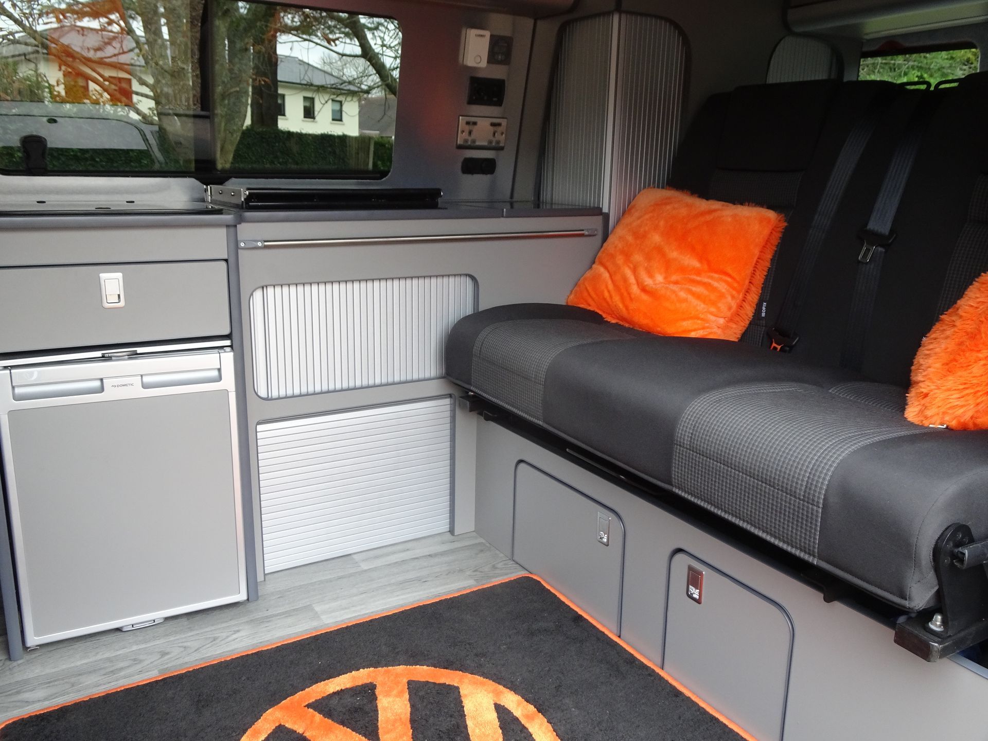 The inside of a van with a volkswagen logo on the floor