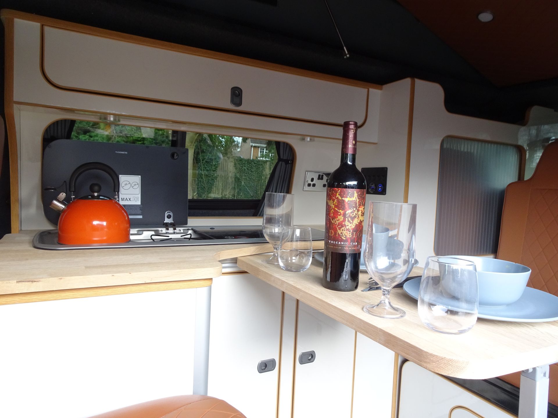 A bottle of wine sits on a table in a kitchen