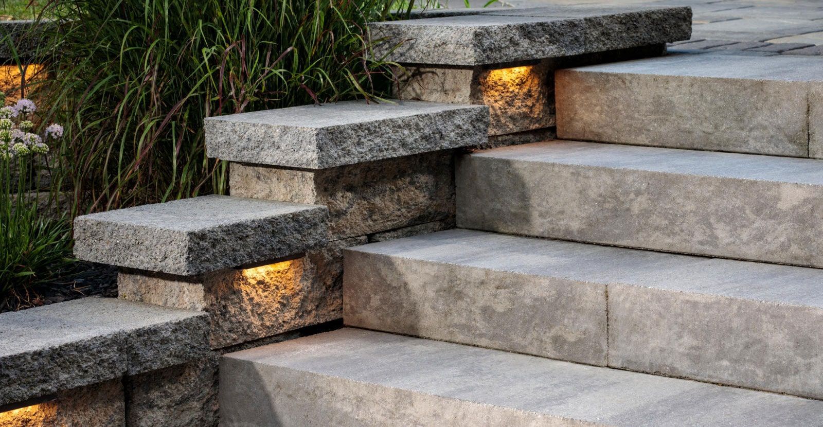 A screened in porch with a brick house in the background.