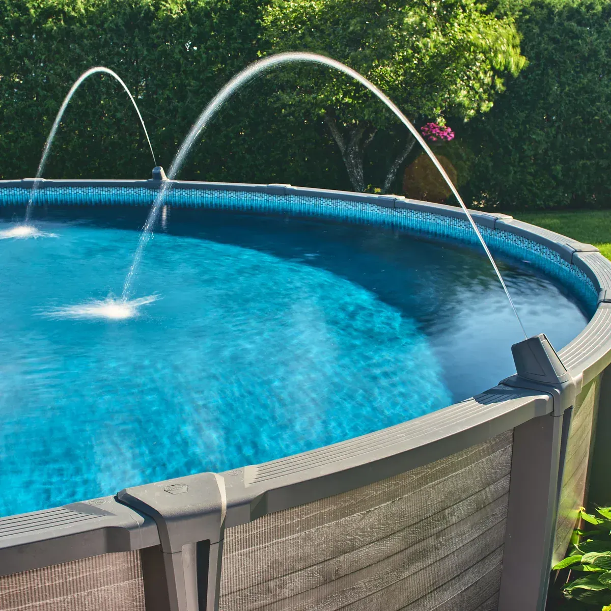 Curved water jets arch into a round above ground pool in Palm Bay, FL
