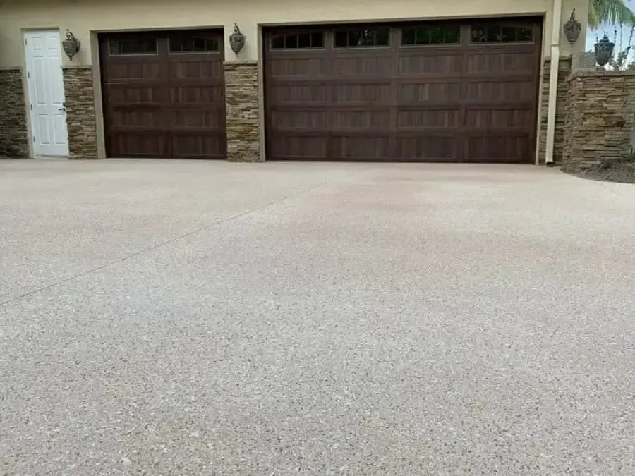 A screened in porch with a brick house in the background.