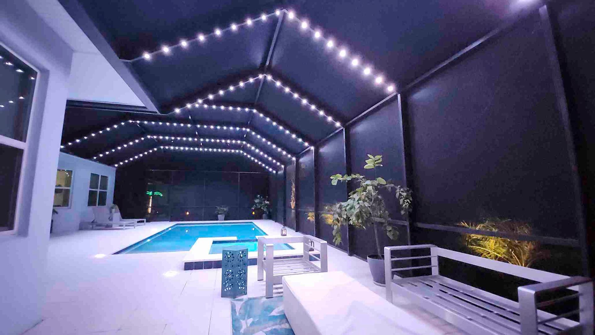 A large indoor swimming pool with a clear roof.
