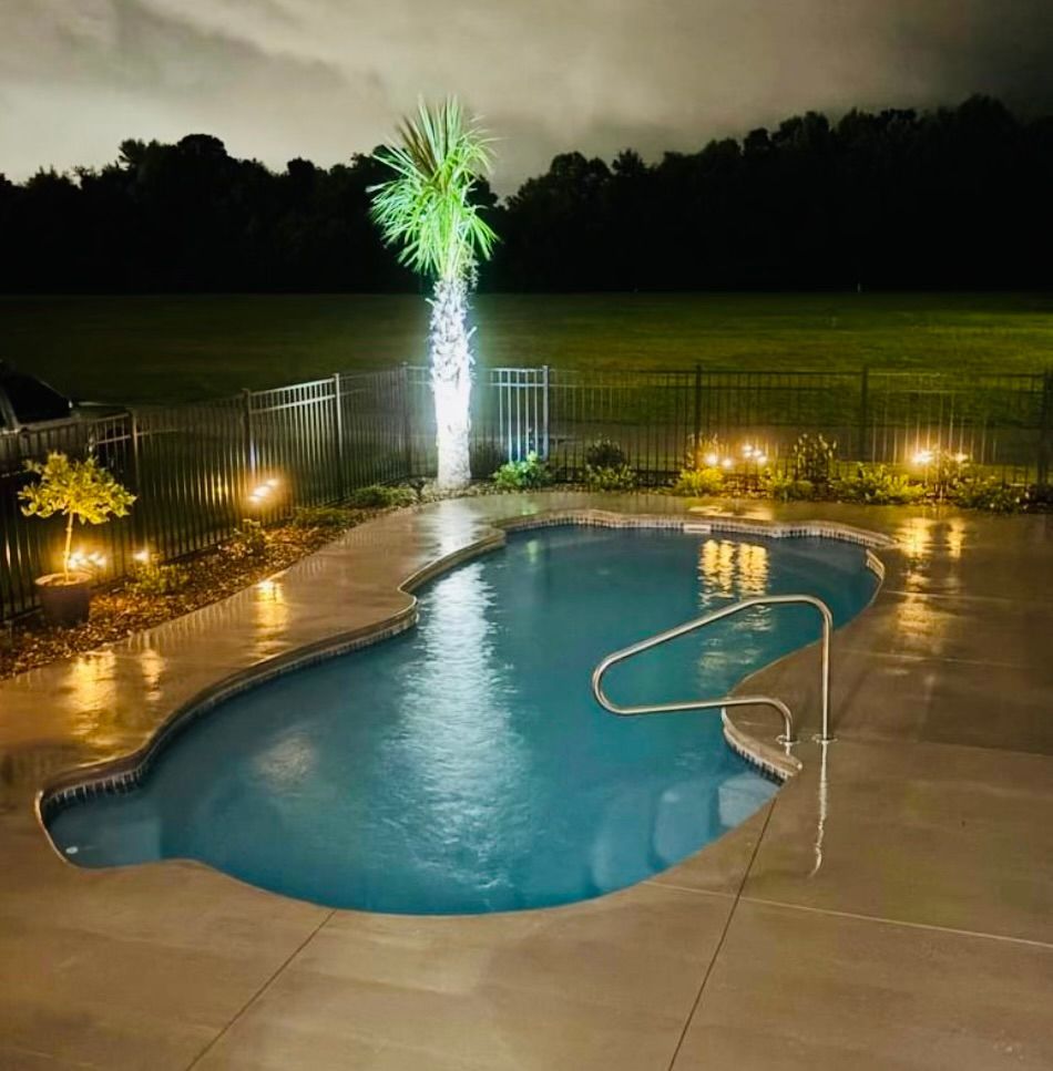 Screened-in pool area with a curved pool, and paver patio