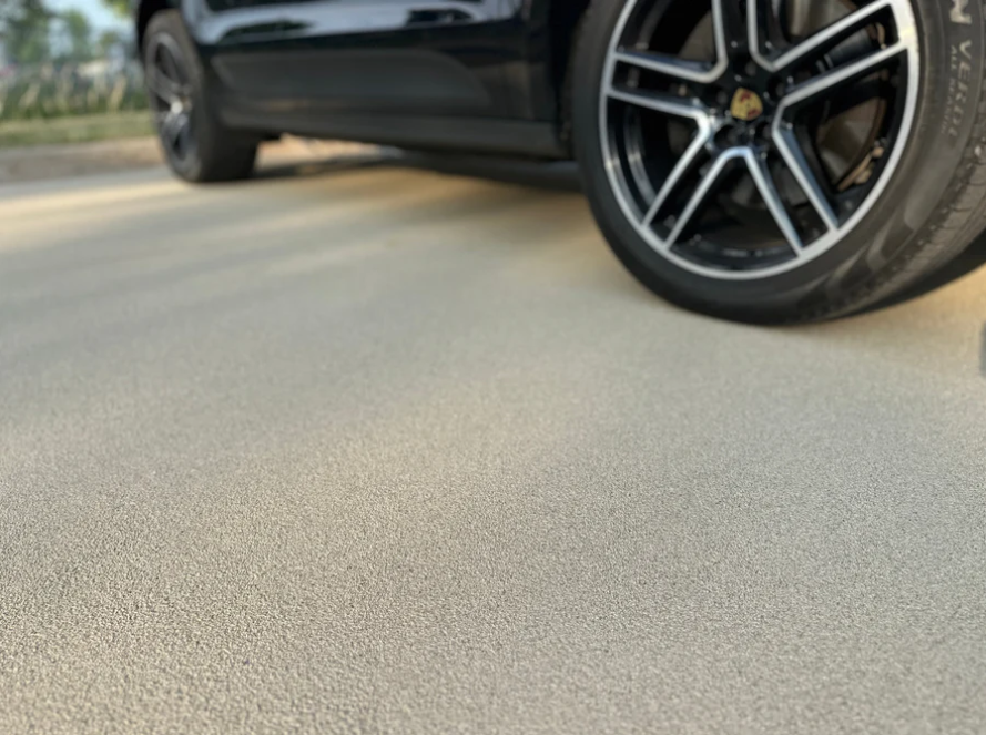 A screened in porch with a brick house in the background.