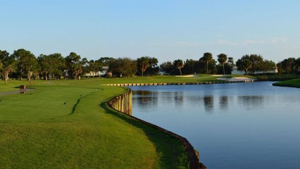 A pier leading into the ocean at sunset