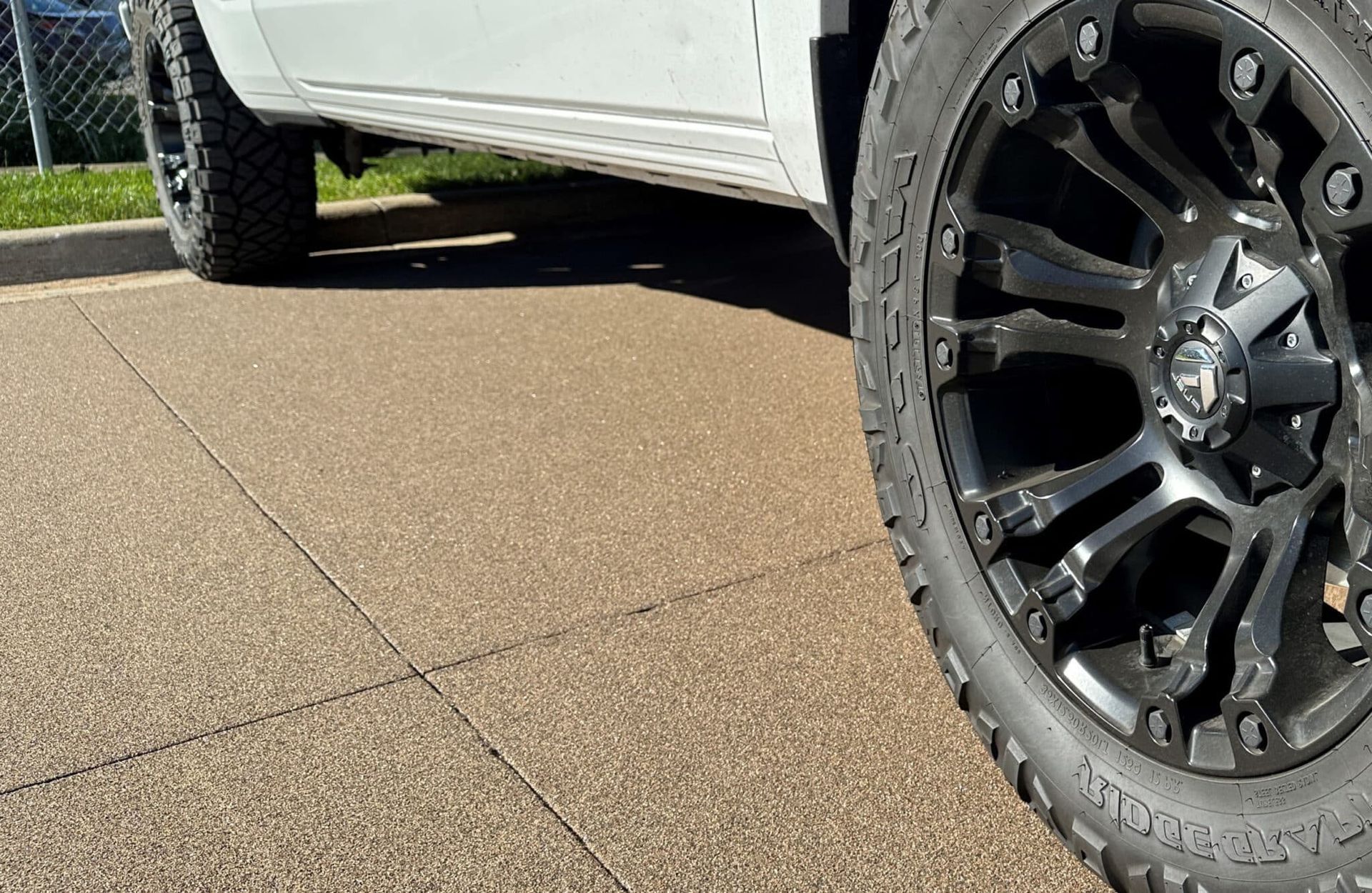 A screened in porch with a swimming pool in the background