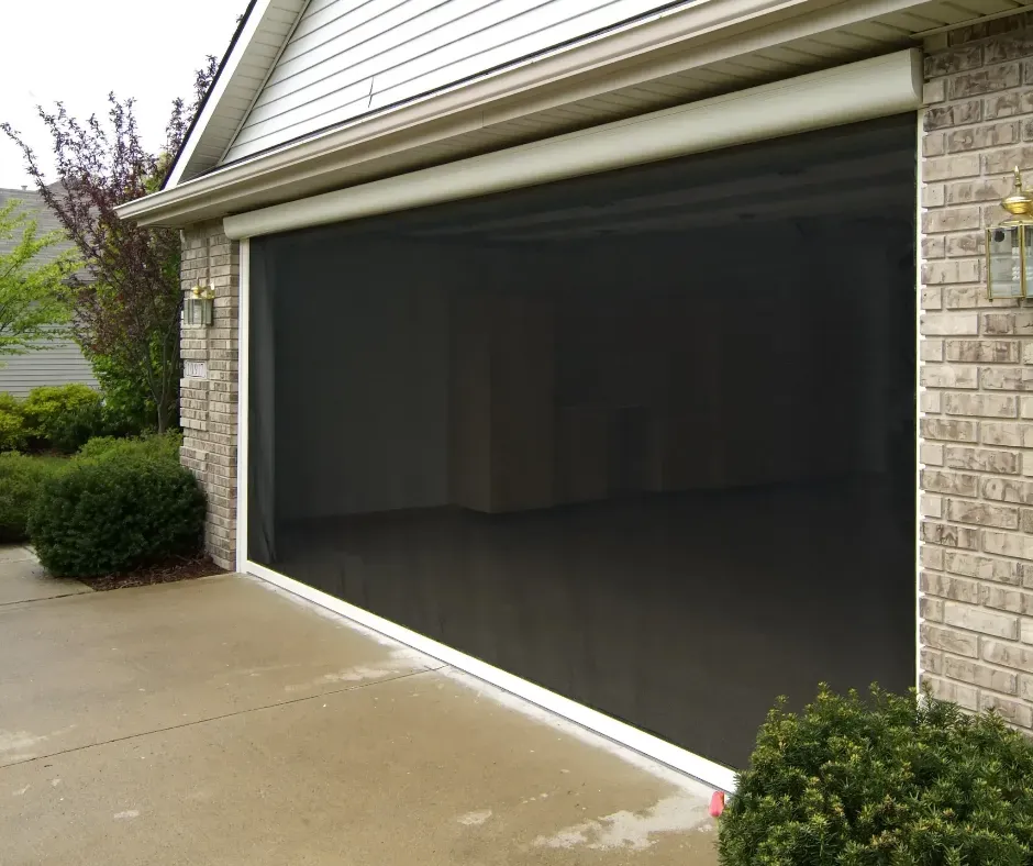 A screened in porch with a swimming pool in the background