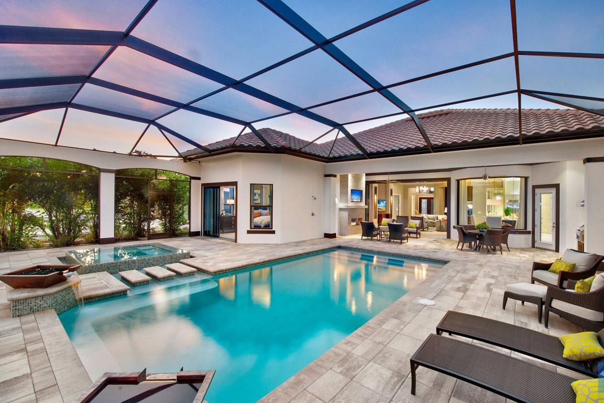 A swimming pool with a screened in area and steps leading to it.