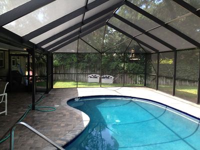 A large indoor swimming pool with a clear roof.