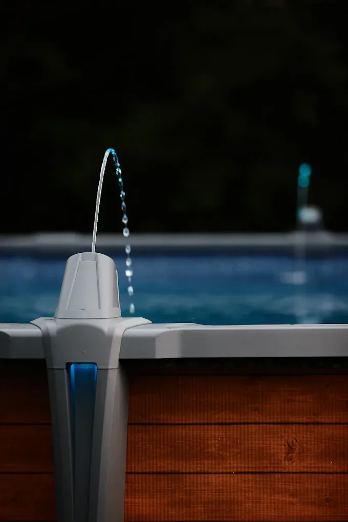 Screened-in pool area with a curved pool, and paver patio