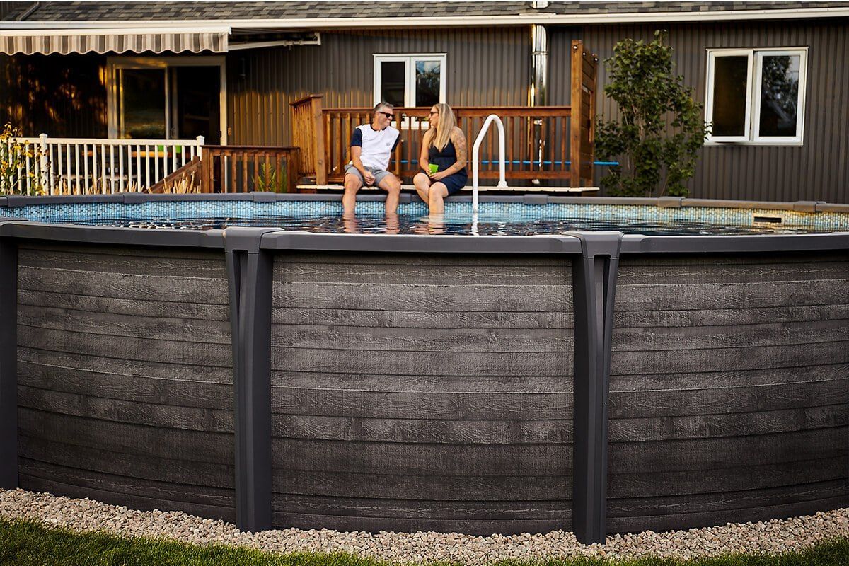 Screened-in pool area with a curved pool, and paver patio