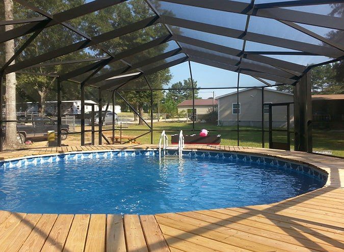 Family-friendly above-ground pool with paver deck and screen enclosure in Vero Beach, Florida